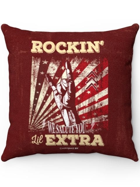 red pillow featuring design with a hand making the rock n' roll symbol and text 'Rockin' lil Extra' and 'We Salute You' for down syndrome awareness