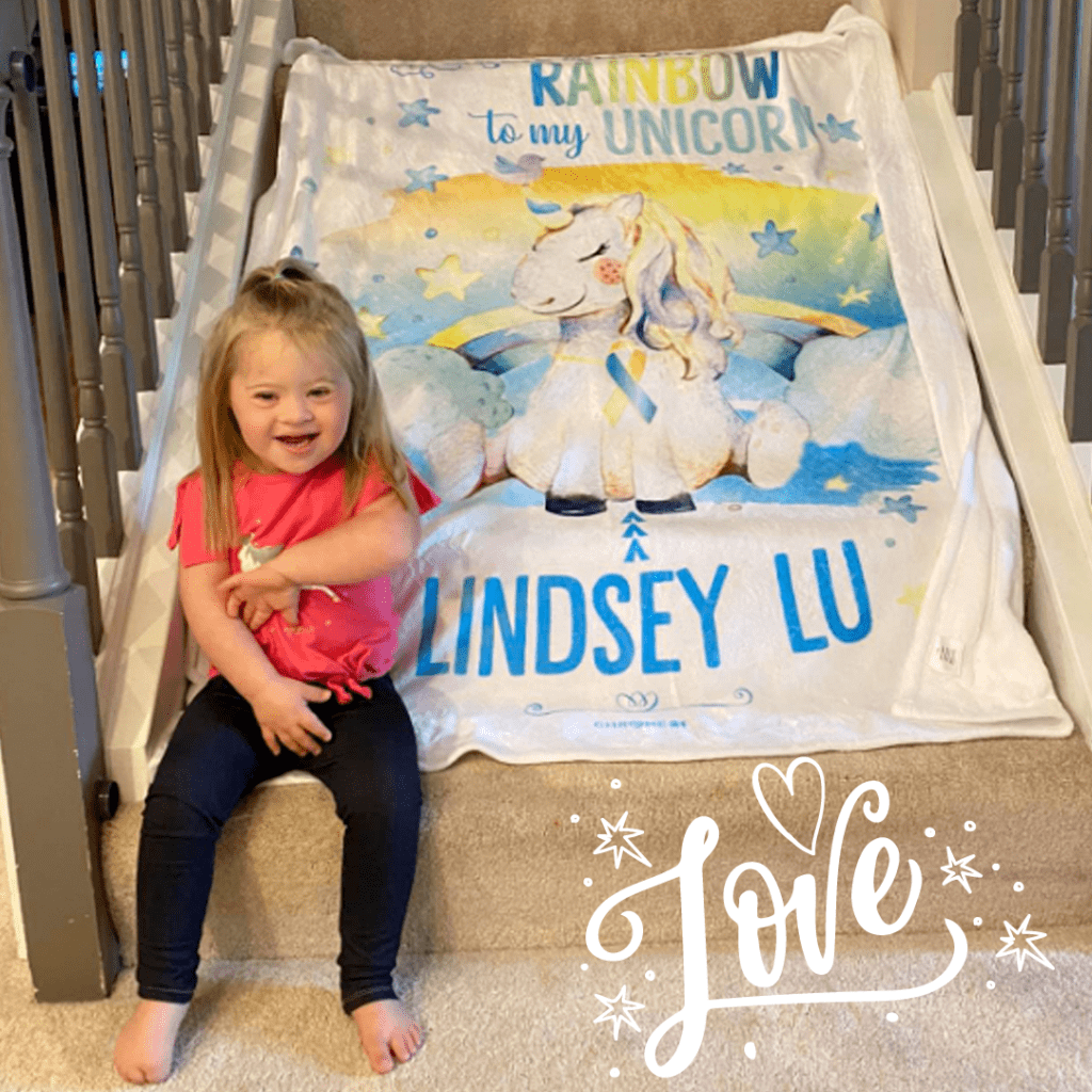 Personalized Blanet for Down Syndrome with blue and yellow and a unicorn with words 'you are the rainbow to my unicorn' [name]
