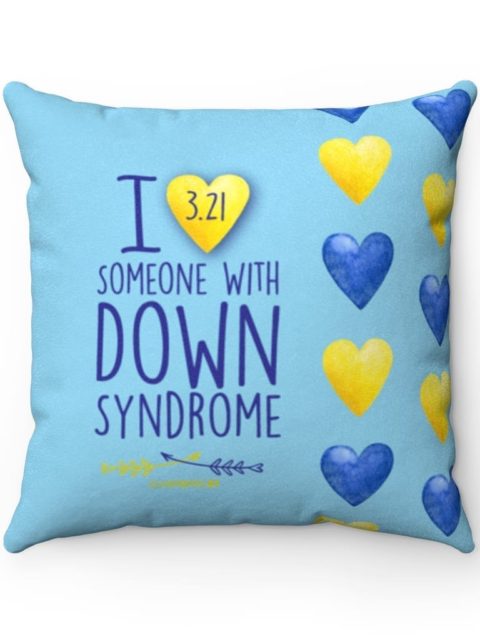 light blue pillow with yellow and blue hearts and blue text 'I (heart) someone with Down syndrome' with '3.21' written in the heart for down syndrome awareness