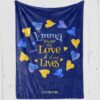 Custom blanket for Down Syndrome Awareness on blue plush fleece with yellow and blue hearts and yellow and blue text '[name] you are the love of our lives'