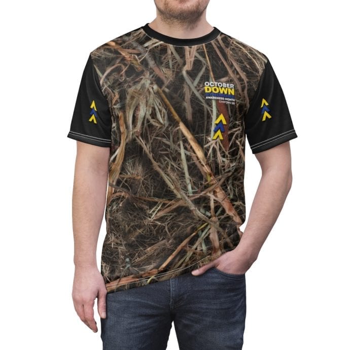 Custom camo shirt for Down Syndrome Awareness with black sleeves and the blue and yellow awareness arrows. October is Down Syndrome Awareness Month Words on front.