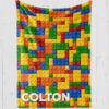 Personalized blanket with lego toys with green, yellow, red, blue lego blocks and white text personalized [name]