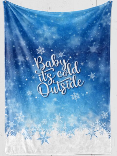 'Baby It's Cold Outside" in white lettering on Blue Plush Christmas Blanket with Snowflakes